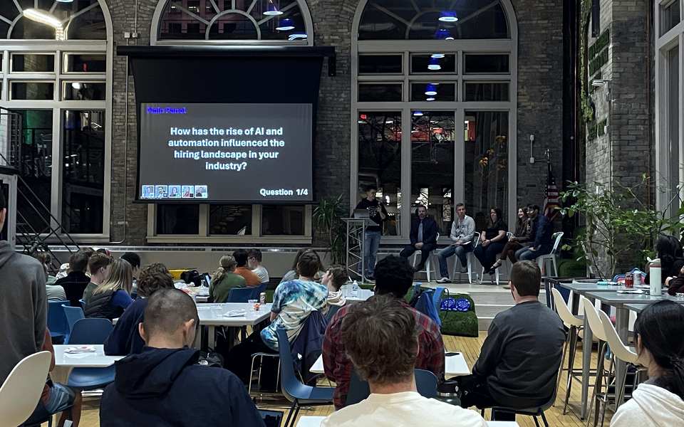 Employers on stage answer a student question about AI and hiring.